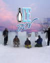 Group posing in front of large ice sculpture letters spelling "Carnaval" at the North Bay winter event.